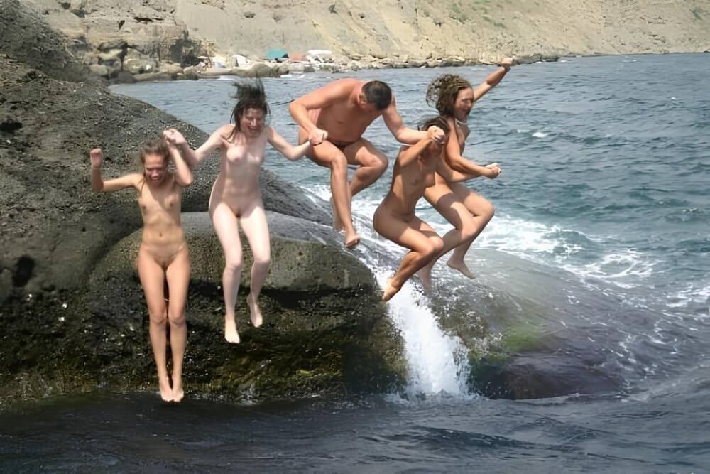 Mens and girls nudists on a beach - Naturism and environmental awareness in the modern world